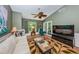 Bright living room featuring a comfortable seating area and large TV at 1377 N Mcmullen Booth Rd # 1377, Clearwater, FL 33759