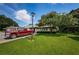 Exterior view of a charming villa with lush landscaping and a spacious lawn at 1377 N Mcmullen Booth Rd # 1377, Clearwater, FL 33759