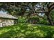 Large backyard with lush grass and mature trees at 1377 N Mcmullen Booth Rd # 1377, Clearwater, FL 33759