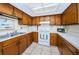 Clean and functional kitchen featuring wood cabinets and modern appliances at 1377 N Mcmullen Booth Rd # 1377, Clearwater, FL 33759