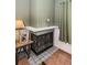 Corner fireplace with tiled surround and metal screen at 1377 N Mcmullen Booth Rd # 1377, Clearwater, FL 33759