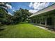 View of home's screened porch and expansive backyard at 1377 N Mcmullen Booth Rd # 1377, Clearwater, FL 33759