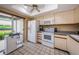 Bright kitchen featuring white appliances and a view to the backyard at 1377 N Mcmullen Booth Rd # 1377, Clearwater, FL 33759