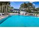 Community pool with a clubhouse in the background, offering a resort-style experience at 1377 N Mcmullen Booth Rd # 1377, Clearwater, FL 33759