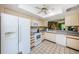 White appliances and light cabinetry highlight this eat-in kitchen at 1377 N Mcmullen Booth Rd # 1377, Clearwater, FL 33759