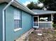 Side view of the house with a screened porch at 7267 Teaberry St, Englewood, FL 34224