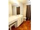 Bathroom with double vanity, shower, and tile flooring at 7267 Teaberry St, Englewood, FL 34224