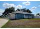 Single car garage with white door and a small fenced yard at 7267 Teaberry St, Englewood, FL 34224