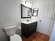 Clean bathroom, dark vanity, tile floor, and a white toilet at 7267 Teaberry St, Englewood, FL 34224