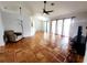 Bright living room with tile floors, ceiling fan, and sliding glass doors at 7267 Teaberry St, Englewood, FL 34224