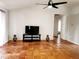 Living area with tile floors, a TV, and access to other rooms at 7267 Teaberry St, Englewood, FL 34224