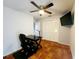 Home office with tile floors, ceiling fan, and built-in desk at 7267 Teaberry St, Englewood, FL 34224