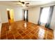 Large bedroom with tile floors, ceiling fan, and window coverings at 7267 Teaberry St, Englewood, FL 34224