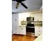 Kitchen with white cabinets and stainless steel appliances at 7267 Teaberry St, Englewood, FL 34224