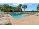 Sparkling community pool surrounded by lounge chairs and lush landscaping at 3051 Overlook Pl, Clearwater, FL 33760