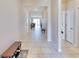 Bright and spacious entryway with tile flooring and bench at 30964 Penny Surf Loop, Wesley Chapel, FL 33545