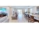 Open concept kitchen and living area with granite countertops and island at 30964 Penny Surf Loop, Wesley Chapel, FL 33545