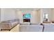 Spacious living room featuring comfortable sofas and a large TV at 30964 Penny Surf Loop, Wesley Chapel, FL 33545