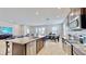 Open kitchen with granite island, stainless steel appliances, and breakfast bar at 30964 Penny Surf Loop, Wesley Chapel, FL 33545