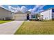 Charming one-story house with two-car garage and landscaped lawn at 30964 Penny Surf Loop, Wesley Chapel, FL 33545