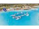 Aerial view of Crystal Lagoon with water features, sandy beach, and lounge chairs at 30964 Penny Surf Loop, Wesley Chapel, FL 33545