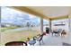 Covered patio features lake views and seating at 30964 Penny Surf Loop, Wesley Chapel, FL 33545