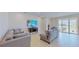 Bright living room with access to a patio and view of the backyard at 30964 Penny Surf Loop, Wesley Chapel, FL 33545