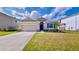 Charming one-story house with two-car garage and landscaped lawn at 30964 Penny Surf Loop, Wesley Chapel, FL 33545