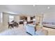 Open-concept living room and kitchen with ample seating at 30964 Penny Surf Loop, Wesley Chapel, FL 33545