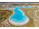 Aerial view of Crystal Lagoon amenity with surrounding landscape at 30964 Penny Surf Loop, Wesley Chapel, FL 33545