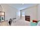Bedroom with a desk, chair, and comfortable sofa at 30964 Penny Surf Loop, Wesley Chapel, FL 33545