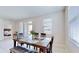 Bright dining room with table, bench, and view into bedroom at 30964 Penny Surf Loop, Wesley Chapel, FL 33545