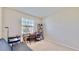 Well-lit bedroom featuring a desk, chair, bookshelf, and window with blinds at 30964 Penny Surf Loop, Wesley Chapel, FL 33545