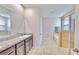 Clean bathroom with double vanity, shower, and bathtub at 30964 Penny Surf Loop, Wesley Chapel, FL 33545