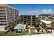 Aerial view of condo building, pool, and surrounding area at 17710 Gulf Blvd # 202, Redington Shores, FL 33708