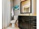 Clean bathroom with shower, toilet and dark vanity at 331 Cleveland St # 317, Clearwater, FL 33755