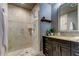 Bathroom with walk-in shower and dark vanity at 331 Cleveland St # 317, Clearwater, FL 33755
