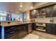 Modern kitchen with dark cabinets, granite countertops, and stainless steel appliances at 331 Cleveland St # 317, Clearwater, FL 33755