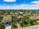 Stunning aerial view of a coastal community with beautiful homes, lush landscaping, and serene waterfront access at 620 Ponce De Leon Dr, Tierra Verde, FL 33715