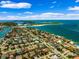 Picturesque aerial view of an island community with a mix of homes, white sandy beaches, and sparkling turquoise waters at 620 Ponce De Leon Dr, Tierra Verde, FL 33715