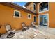 Backyard patio with outdoor furniture and Travertine tile at 620 Ponce De Leon Dr, Tierra Verde, FL 33715