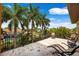 Relaxing balcony featuring outdoor lounge furniture and palm tree views at 620 Ponce De Leon Dr, Tierra Verde, FL 33715