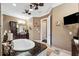 Well-appointed bathroom with a soaking tub, dark wood cabinetry, and plenty of counter space at 620 Ponce De Leon Dr, Tierra Verde, FL 33715
