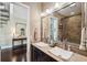 A bright bathroom with double sinks that lead to the main room at 620 Ponce De Leon Dr, Tierra Verde, FL 33715