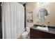 Bathroom featuring a sleek vanity, decorative mirror, and tiled shower with glass door at 620 Ponce De Leon Dr, Tierra Verde, FL 33715
