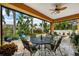 Relaxing covered patio with cozy seating, perfect for enjoying the beautiful garden views and outdoor living at 620 Ponce De Leon Dr, Tierra Verde, FL 33715
