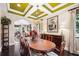 Formal dining room showcasing a large table, hardwood floors, and natural light from the large windows at 620 Ponce De Leon Dr, Tierra Verde, FL 33715