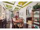 Elegant dining room features a coffered ceiling and wood flooring, creating a warm and inviting space at 620 Ponce De Leon Dr, Tierra Verde, FL 33715