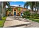 Stunning two-story Mediterranean-style home with a paver driveway, manicured landscaping, and a three-car garage at 620 Ponce De Leon Dr, Tierra Verde, FL 33715