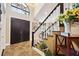 Elegant two-story foyer with marble floors, a staircase with dark wood and white banisters, and a grand entrance at 620 Ponce De Leon Dr, Tierra Verde, FL 33715